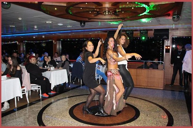 Istanbul Bosphorus Cruise with Dinner and Belly-Dancing Show - Sunset landmarks: Blue Mosque and Dolmabahçe Palace from the shoreline